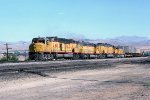 UP 6910 west with two Centennials and two Fast forties approaches East Barstow with it's caboose halfway to Nebo.